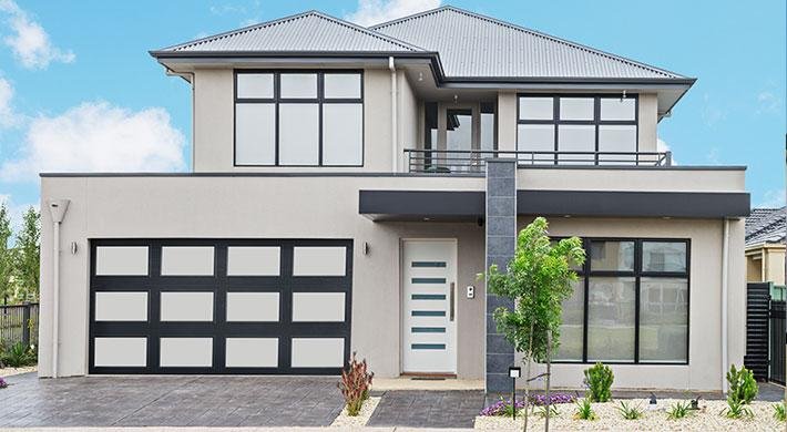 Modern garage door with glass panels on a stylish suburban home, showcasing enhanced curb appeal and contemporary design.