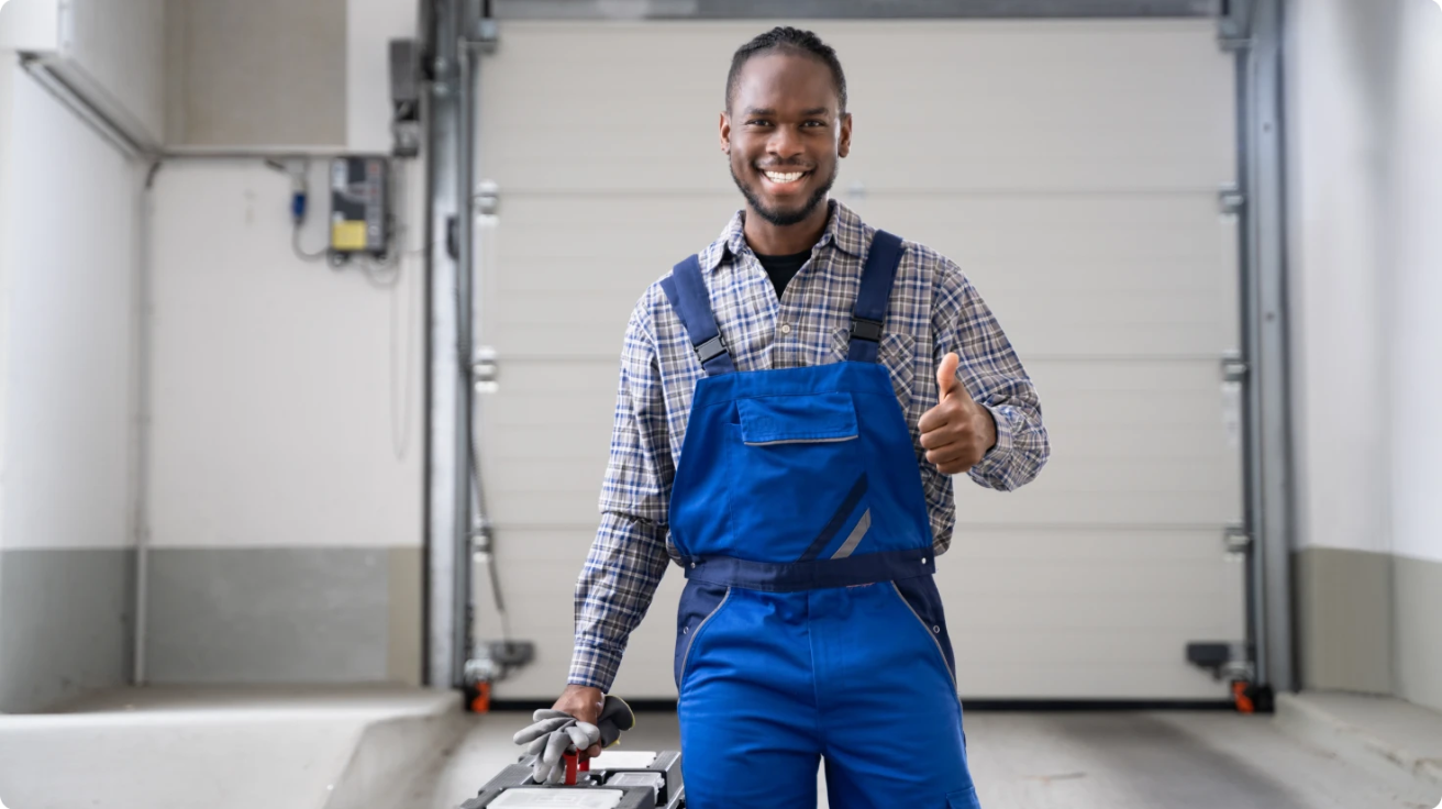 A technician inspecting a garage door system, checking springs, rollers, and tracks for optimal performance and safety.